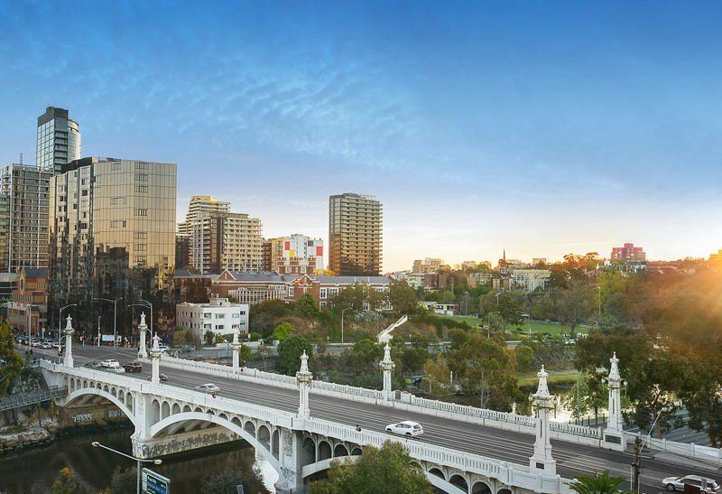 Bridge over the Yarra River at sunset with Richmond apartments beyond