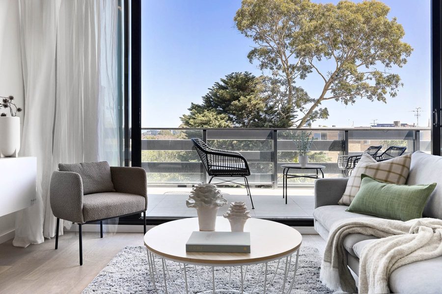 Apartment living room opening onto a leafy balcony